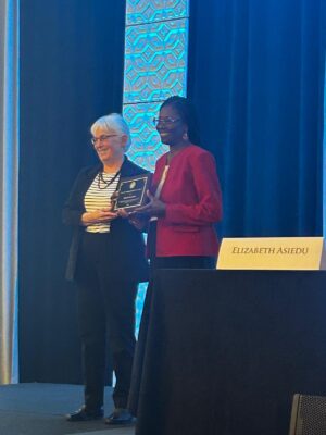 Elizabeth Asiedu receiving AEA Distinguished Service Award